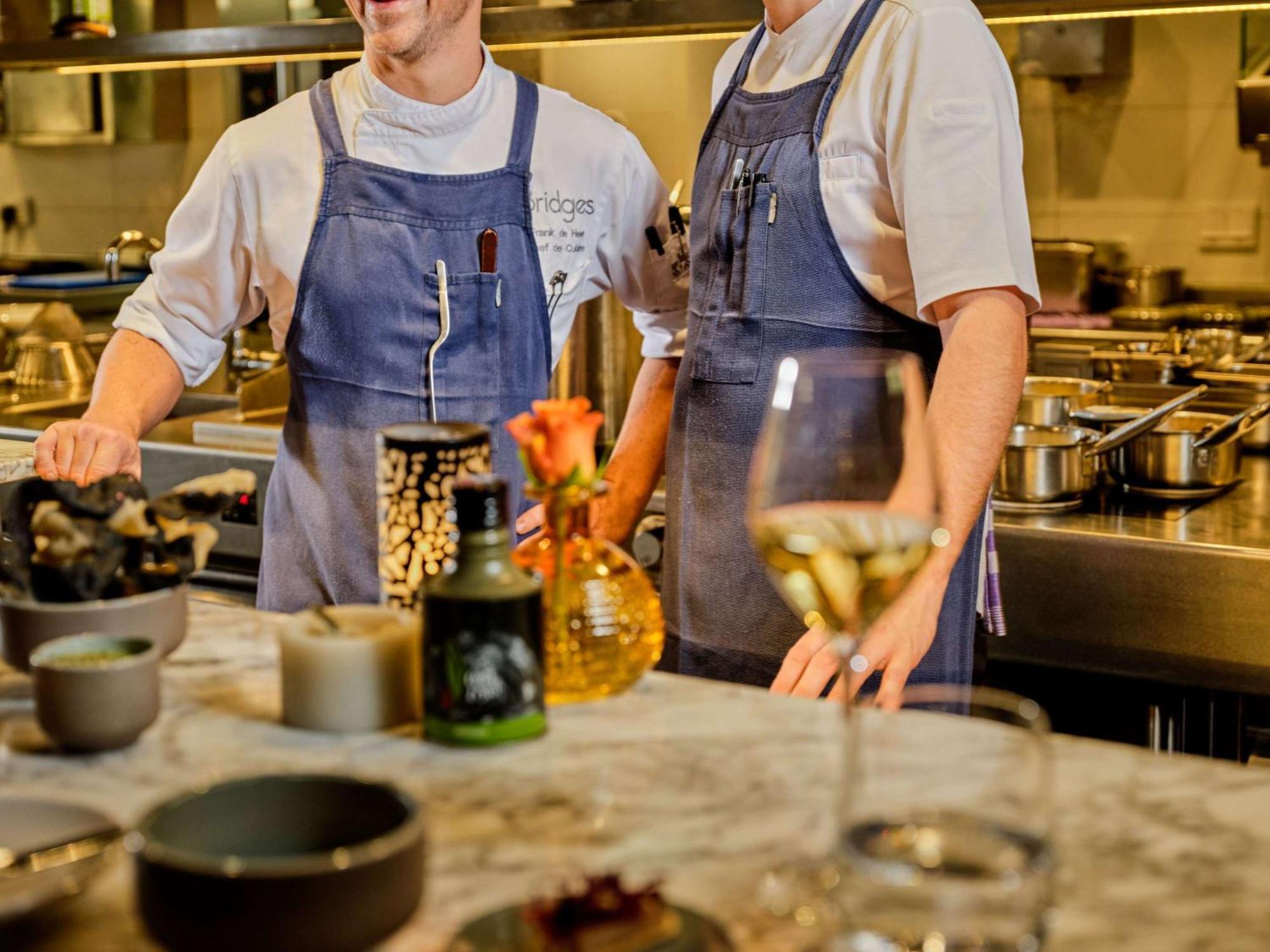 Sofitel Legend The Grand Amsterdam Hotel Exterior photo Two chefs in a restaurant kitchen